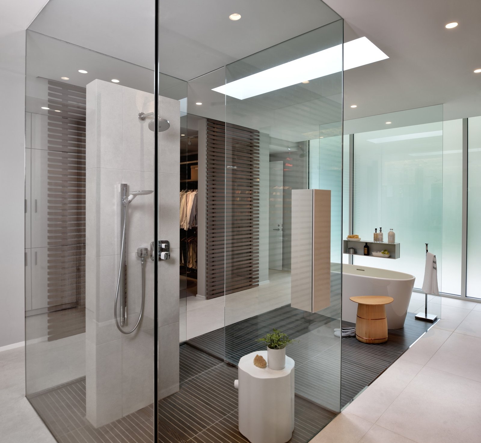 Baño luminoso con regadera de cristal y grifería Hansgrohe
